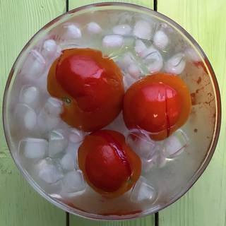 Remove the tomatoes from boiling water and plunge them into the iced water to cool them down quickly.