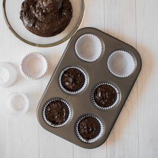 Put cupcake papers into your tin. Pour the batter inside them and put the tin inside the oven. Remember, don't overfill them with batter. The cupcakes would rise when you bake them.