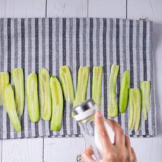 Peel and cut the cucumbers. Put them on a paper towel and season them with salt. Let them rest for 20 minutes. This is optional but takes the excess water in the cucumbers and prevents the sandwiches to become too moist.