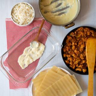 Now, grease into the baking dish and spread a layer of Béchamel sauce.