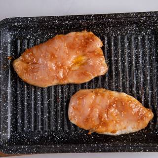 After about one hour, heat a grill pan and grill each side of the chickens for 10 minutes.