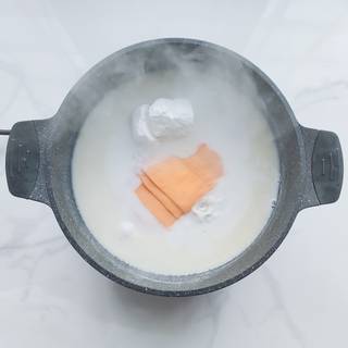 Add the cream cheese, cheddar, and half of the parmesan to the boiling milk and stir until they are combined. Now add one tablespoon of mustard to the mixture.