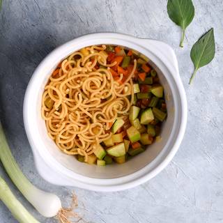 After frying and cooking the vegetables you need to add the pasta with a cup of water to the pot.