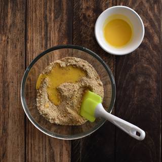 Place the digestive biscuits in a food processor, or inside a ziplock and crush them using a rolling pin. Then add in the room temperature butter which should have already softened up by now. Now start mixing and stirring really well.