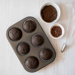 After 20 minutes take the cupcakes outside the oven. while they are cooling down we start making our chocolate frosting. Whisk the whipped cream with melted chocolates. Don't do it too much or your cream would lose its structure.