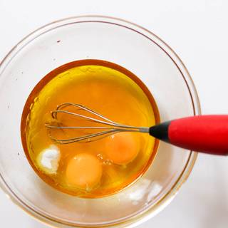 Add eggs with vanilla into the oil and honey whisk and beat it in order to mix it well.