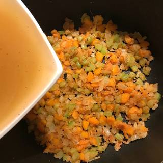 Cook the mixture while stirring constantly until medium brown then pour in the beef broth.