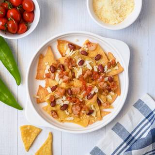 Spread one layer of tortilla chips on the button of the skillet. Scatter some cheese, red beans, and shrimp on the top of the tortilla and combine it with salsa sauce. 