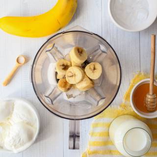 Slice bananas and put them in the fridge for 10 minutes. Then mix them with some pieces of ice.