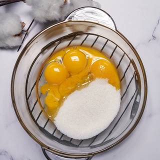 Separate the yolks and mix them with sugar by a mixer until it becomes creamy. Keep one spoon of sugar, you'll need it later.
