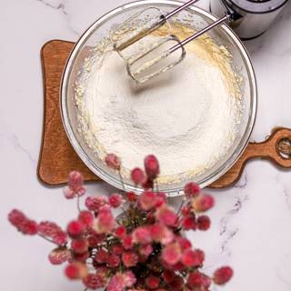 Sieve half of the flour with baking powder, add them to the batter, and whisk them well with the blender.