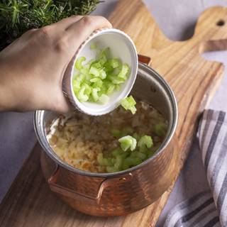 Fry the chopped garlic and onions until they become golden, then add chopped celery.