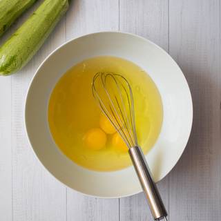 Preheat the oven to 175 °C. Beat the eggs with oil, sugar, and vanilla in a deep bowl until they are combined well.