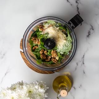 Mix basil, walnuts, parmesan, garlic, olive oil, salt, and pepper in the food processer for two minutes.