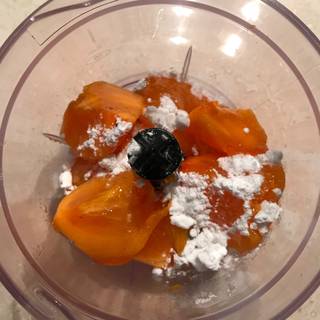 Peel the persimmons and place them in a food processor add icing sugar and lemon juice too.