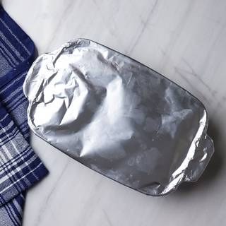 Cover the container with aluminum foil and place it in a preheated oven at 350 Fahrenheit for 50 minutes.