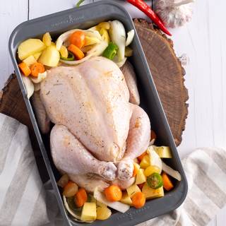 Now put the vegetables beside your chicken and put it in the preheated oven for 2 to 2 hours and 30 minutes at 185C. 