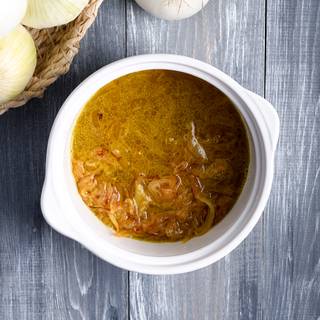 Add the chicken stock to your caramelized onions and higher the heat to make it come to a boil, then lower the heat again till the soup thickens.