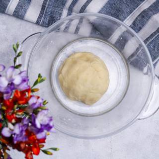 After mixing the butter and flour, Add 6-7 spoons of cold water and Knead it until the dough forms well. you can use the dough instantly without resting or give it a rest for about one hour in the refrigerator. Your dough is going to be softer if you let it rest.