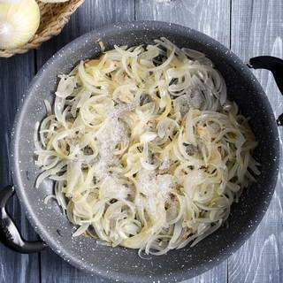 Close the lid and let the onions cook for 15 minutes on low heat. After 15 minutes the onions have became soft. Now add a little salt, sugar, and pepper and stir.