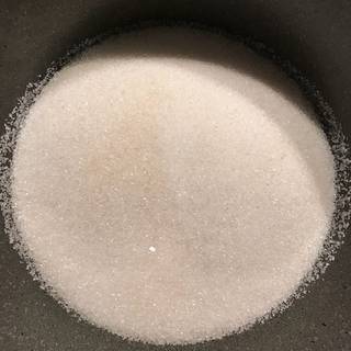 Place the sugar in a sauce pan and shake the saucepan so the sugar lays flat in an even layer.