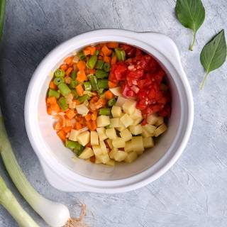 After you fry the carrots and green beans you can cook the washed and chopped potatoes, tomatoes, and zucchini in the pot.