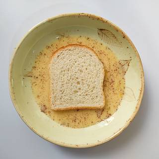 Roll a slice of toast in milk and egg liquid.