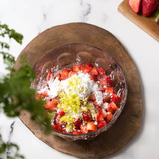 Put the sliced strawberries, fresh lemon juice, corn flour, and sugar in another bowl.