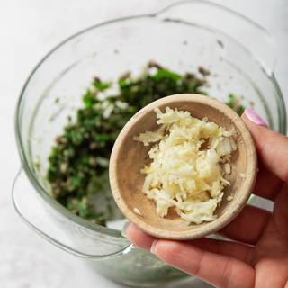 Now add the grated garlic to the mixture.