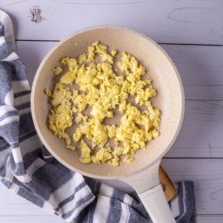 Fry the eggs with some butter in a pan. Separate them into small pieces while frying them. You can put them aside after they are cooked well.