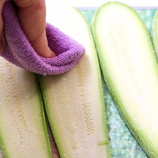 Use a grater or knife to strip the zucchinis. Then spread salt and let it sit for 30 minutes to remove the water from the zucchinis. Then dab them with a paper towel.