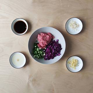 You can fill the dumpling with ground beef, red cabbage, spring onions, garlic, soy sauce, and spices.