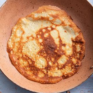 Before cooking each crepe, butter the pan well. Use the remaining butter to grease the pan and fry the crepes one by one.