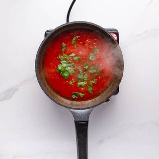 Chop basil and add it to the sauce when it's almost ready with the lid off. You can turn off the stove after 1 minute.