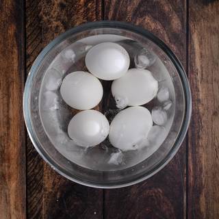 Take the eggs out of the boiling water after 20 minutes and put them in ice water. This helps you remove the shell easier.