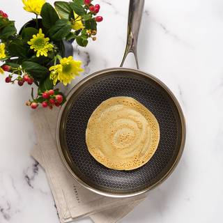 Pour one ladle of batter onto the pan. Tilt the pan with a circular motion so that the batter completely covers the bottom of the skillet or you can use your same ladle to help cover the pan. 