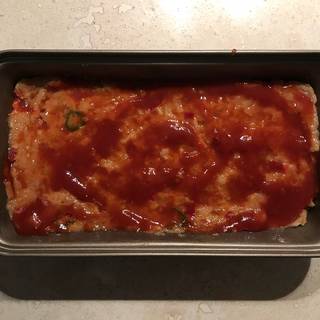 Pour the ketchup over the turkey meatloaf. Place the loaf pan in preheated oven and bake the meatloaf for about 45 minutes.