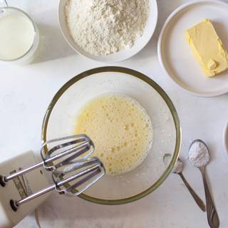 In a large bowl, whisk egg, sugar, and vanilla. Add melted butter and milk to the mixture; whisk until moistened.