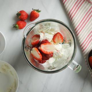 Halve the strawberries to mix better. then add to the ice cream.