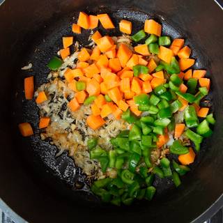 Once your onions look golden, add in the chopped-up vegetables. 