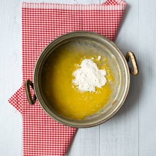Melt extra butter over low heat and gently stir in flour. Stir in stock and mix until smooth.