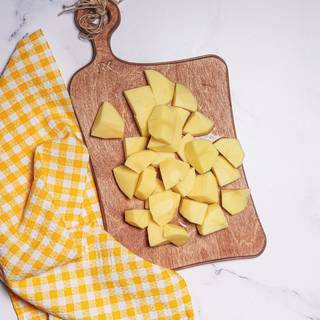 Peel and cut the potatoes into pieces and cook them.