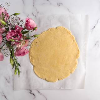 Using a bottle or rolling pin, roll dough into a round.