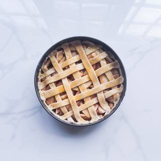 Cut the second batch of dough into strips for the lattice. brush the yolk on the top of the pie, then put it into the oven.