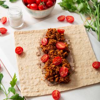 Put one layer of beef on the mashed beans. Fry some tomatoes and put them on top of your beef.