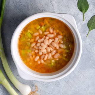 Add the white beans, salt, and pepper to the boiling soup. Lower the heat until it is cooked perfectly and the pasta and vegetables are softened.