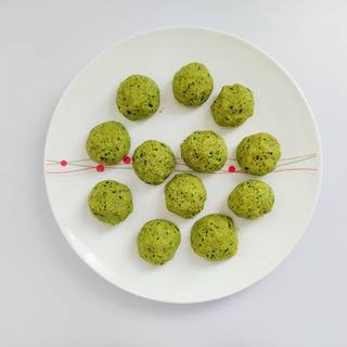 Make falafel balls with your hands or use a scoop to help you shape them better.