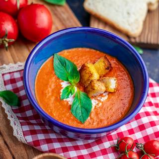Our tomato soup is ready in a few minutes. You can decorate it with some cream and basil.