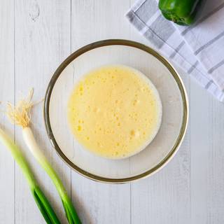 Beat the egg in a large bowl until it's combined well and full of bobbles. 