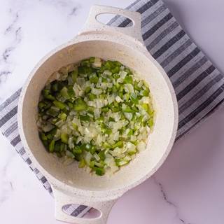 Fry the chopped garlic and onion with butter on the heat. Add the bell pepper and fry them until they are soft.